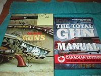 Photo showing cover of two books: 'The Great Guns' and 'Field and Stream The Total Gun Manual Canadian Edition' resting on a green cloth surface.