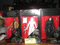Three Star Wars Black Series 6-inch figures still in boxes: Finn, First Order Snow Trooper, Kylo Ren with packaging wear.