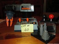 Full view of Radio Shack Armatron robotic arm with control base, clear container with two joystick controls, and gray accessory piece.