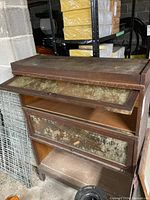Front and side view of the entire bookcase showing three shelves and glass doors partially lifted open