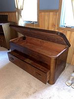 Chest with hinged lid open and bottom drawer extended, showing interior space and drawer