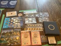 Overview of full lot on table showing all coins, sets and albums