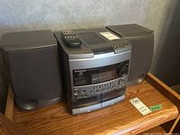 Full view of Pioneer stereo system with receiver, two speakers, and remote control on top. Shows overall condition and setup.