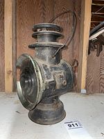 Clear side profile showing the lamp's overall shape, handle, and base with visible wear.