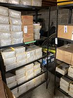 Black metal shelving unit loaded with various boxed items