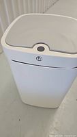 White rectangular automatic trash can with sensor on the lid, showing top and sensor area.
