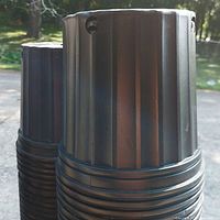 Stack of black ribbed nursery pots showing exterior