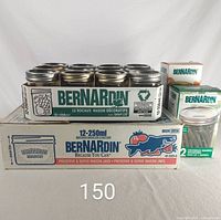 Boxes of Bernardin mason and jelly jars with visible jars stacked on top