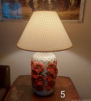 Full view of lamp on table, lit