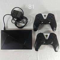 Front view of NVIDIA Shield media player, power adapter and two wireless controllers
