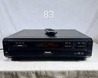 Front view of Toshiba SD-2805 player with remote resting on top