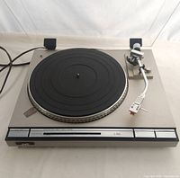 Top view of JVC L-A55 turntable showing platter, tonearm, controls, and power cord
