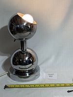 Front view of lamp with measuring tape showing height