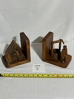 View of both carved wood bookends together showing size and design.