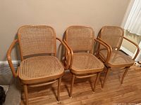 Three bentwood cane chairs side by side