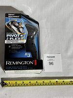 Boxed Remington R3 men's cordless electric shaver measuring about 6 inches long with visible packaging details.