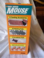 Box side showing 15 sanding accessories, 6 polishing pads, 2 scrubbing pads listed.