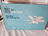 Photo of unopened box of For Living Nordica 36 inch ceiling fan showing fan image and product details