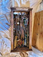 First photo shows a wooden box filled with assorted hand tools including scissors, pliers, screwdrivers, and wrenches in good used condition.