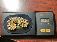 Bracelet placed on digital scale displaying weight 16.7 g