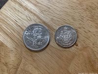 Front view of 1958 Canadian Silver Dollar and 1962 Canadian Fifty Cent Silver Coin showing reverse sides.