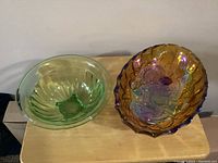 Top view of the two bowls side by side, showing the green Depression glass bowl and the iridescent Carnival glass bowl.