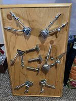 Full display board with 9 vintage chrome barber tools mounted on pine wood.