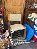 Two photos showing each of the two wooden rocking chairs with beige fabric seats and backrests, placed indoors.