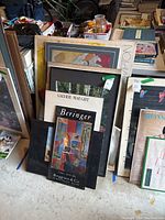 Overall view of stacked framed posters leaning against wall with front Beringer and Jackson Hole Festival.