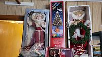 Angel figurine in box, candle tree box, large festive figurine with wreath in box.