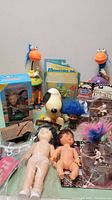 Photo showing the entire lot including dolls, troll figures, Snoopy in packaging, collectible figures and dollhouse accessories