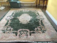 Full view of the 8x10 green and pink hand knotted silk area rug showing floral and medallion design.