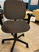 Front view of black rolling office chair with fabric seat and backrest, black armrests and five-wheel base.