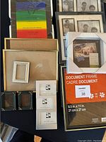Top view of the assortment of photo frames showing various sizes, colors, and types, including packaged document frame and multi-photo frames.