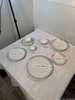 Overview of all china items set on a table with labels indicating quantity and type of each piece.