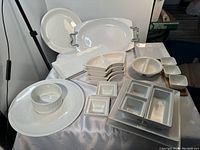 Full view of assortment of white ceramic entertainment serving platters and dishes with no chips or cracks