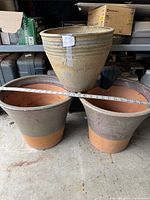 Top image showing all three clay pots with a measuring tape in front indicating size.