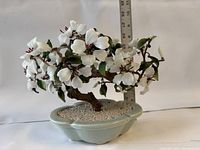 Front and side view of jade and shell bonsai tree sculpture with ruler for size reference.