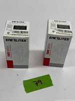 Front view of two sealed boxes of Enerlite HET06A-R timer switches side by side showing product label and box graphics.