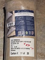 Close-up photo of the rug pad label showing key features, size, weight, and origin.