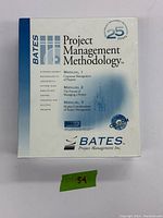 Front cover of project management methodology box, showing title, manual contents, and 25-year branding.