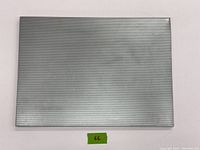 Top view of the rectangular Umbra magnetic and pin board showing the perforated silver metal surface.