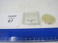 Photo showing 2003 American Mint gold coin replica, certificate of authenticity, and ruler for scale.