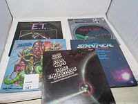 Five vintage movie soundtrack vinyl LP records with album covers featuring E.T., Star Wars, Pops in Space, and others.