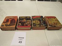 Four vintage Big Little Books titled Terry laid side by side on white surface showing front covers.