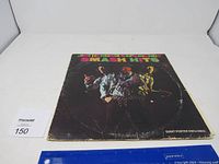 Front of Jimi Hendrix Experience Smash Hits vinyl record album cover showing colorful text and band member images, edges worn.