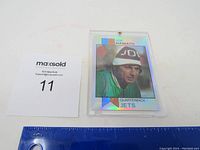 Joe Namath holographic football card replica showing front of card with player's photo and text. Ruler included for scale, card is encased in clear plastic with screw top.