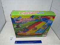 Photo of the Jumbo Triple Lane Water Splash Slide original box showing product branding, image of slide, and included accessories.