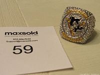 Front view of the replica ring showing Pittsburgh Penguins logo, Stanley Cup champions banner, and rhinestone accents.