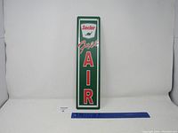 Front full view of Sinclair Free Air metal sign with a ruler for scale, showing green background, Sinclair logo with dinosaur, and Free AIR text.